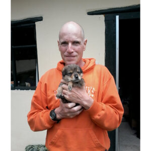 Robert in Peru holding puppy